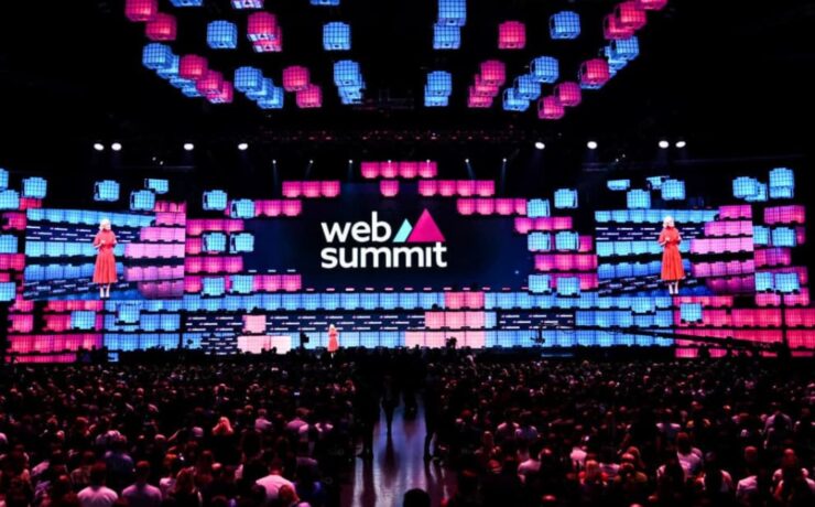 Web Summit 2024 in Lisbon, showcasing a vibrant stage and large audience, highlighting innovation and networking opportunities for startups.